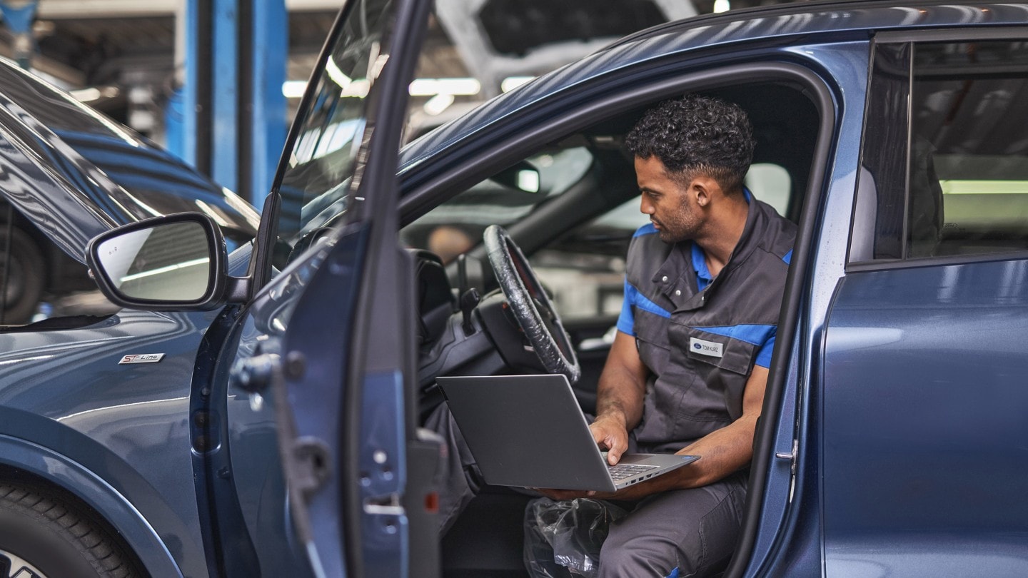 Ford Service engineer, inspecting vehicle