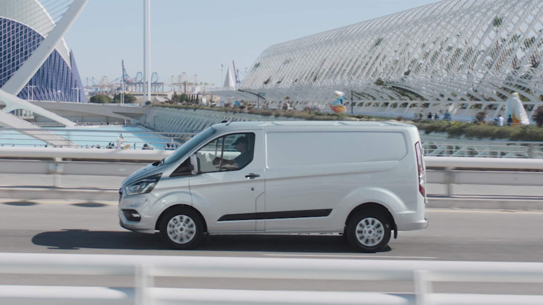 Ford Transit Custom PHEV driving across a bridge