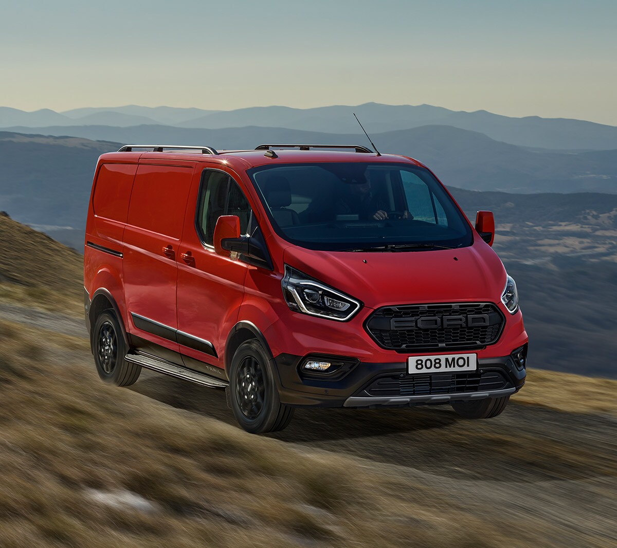 New Orange Ford Transit Custom front angle with three bar grille