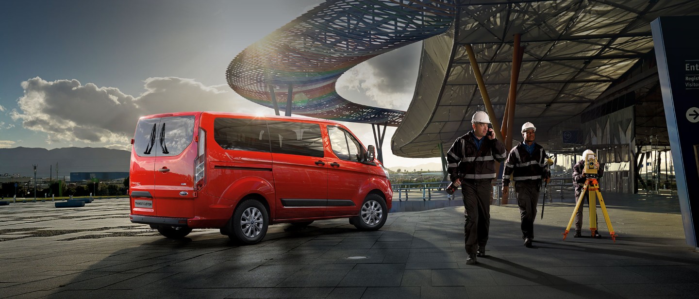 Orange Ford Transit Custom at construction site