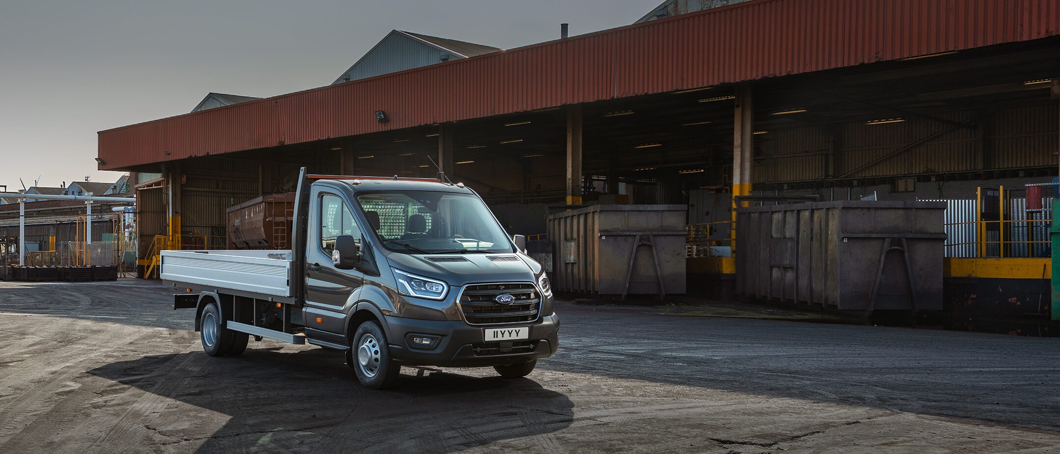 Transit Chassis Cab standing in front of cargo containers