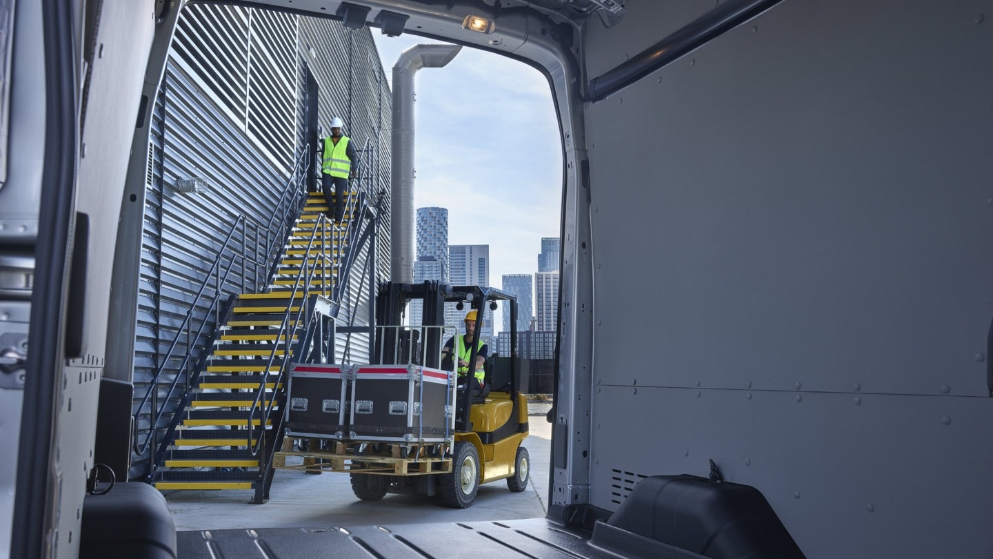 Stairs of building site viewed from inside of Ford E-Transit through open back door