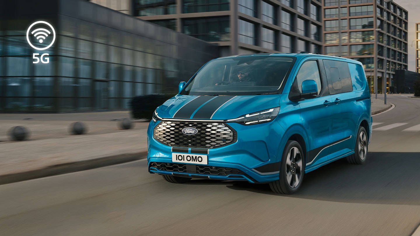 Μπλε ηλεκτρικό van Ford E-Transit Custom που κινείται σε δρόμο στην πόλη.