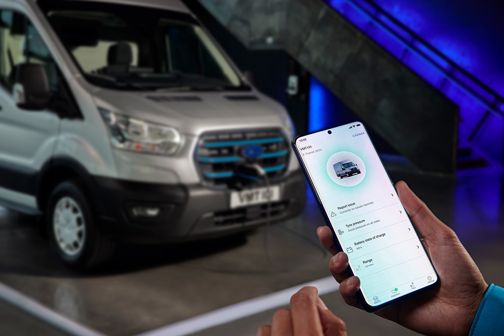 Hand holding mobile phone with Ford Pass app