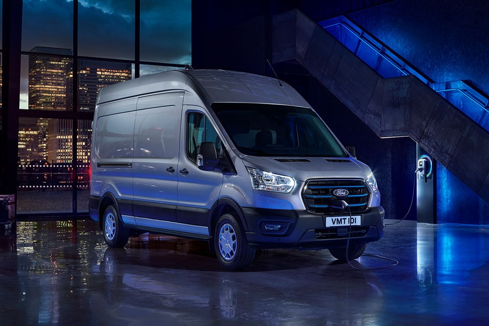 Ford E-Transit Van σταθμευμένο κοντά σε σημείο φόρτισης αμαξοστασίου.