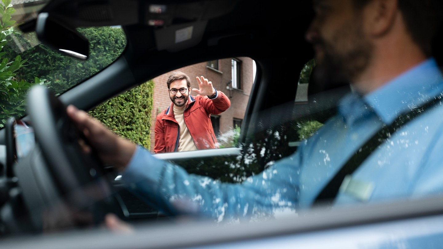 Keys being passed from a Ford representative to a customer